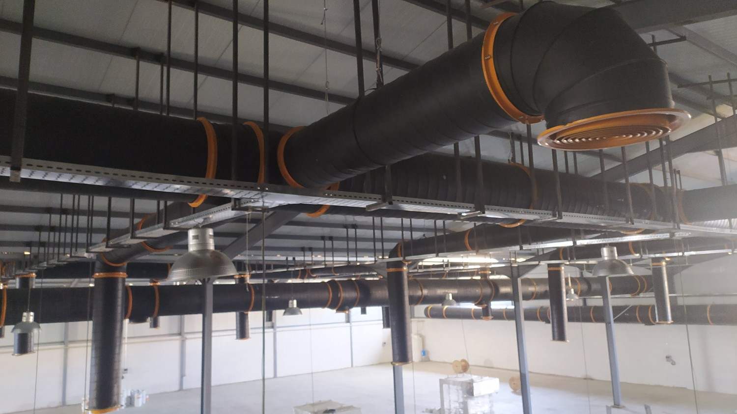 Conditioned air from the air washers is distributed through a network of spiral ducts. Spiral (round) ductwork was selected for its lower pressure drop, higher structural rigidity, faster installation, and cleaner appearance compared with traditional rectangular duct systems.